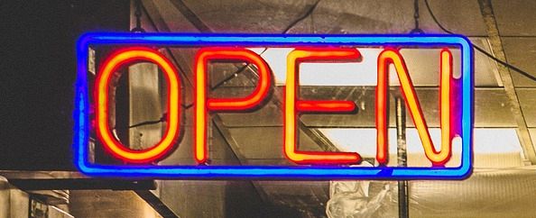 neon sign reads open for a shop
